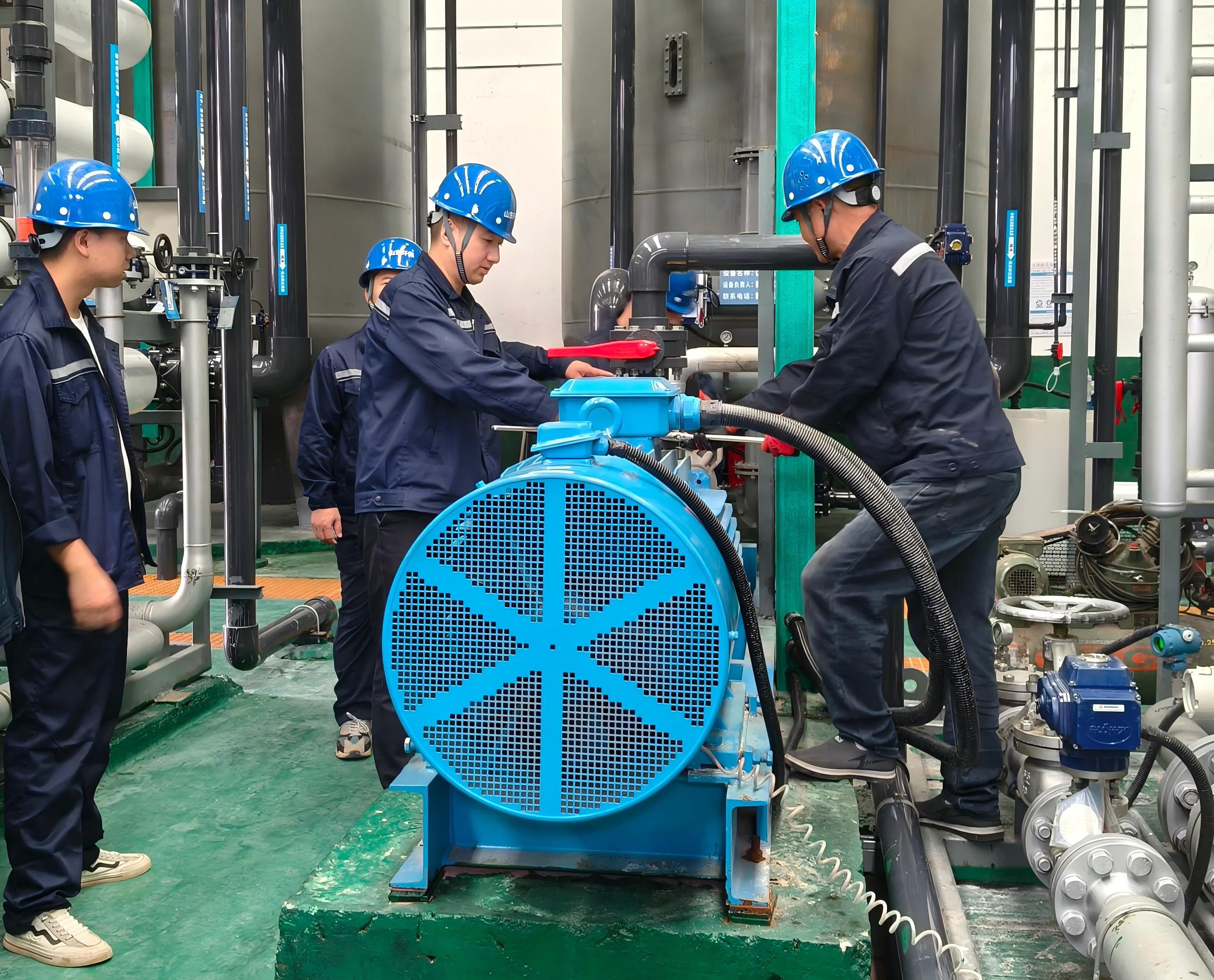 圖為污水車(chē)間主任張學(xué)淵（右二）和同事們調(diào)整設(shè)備.jpg